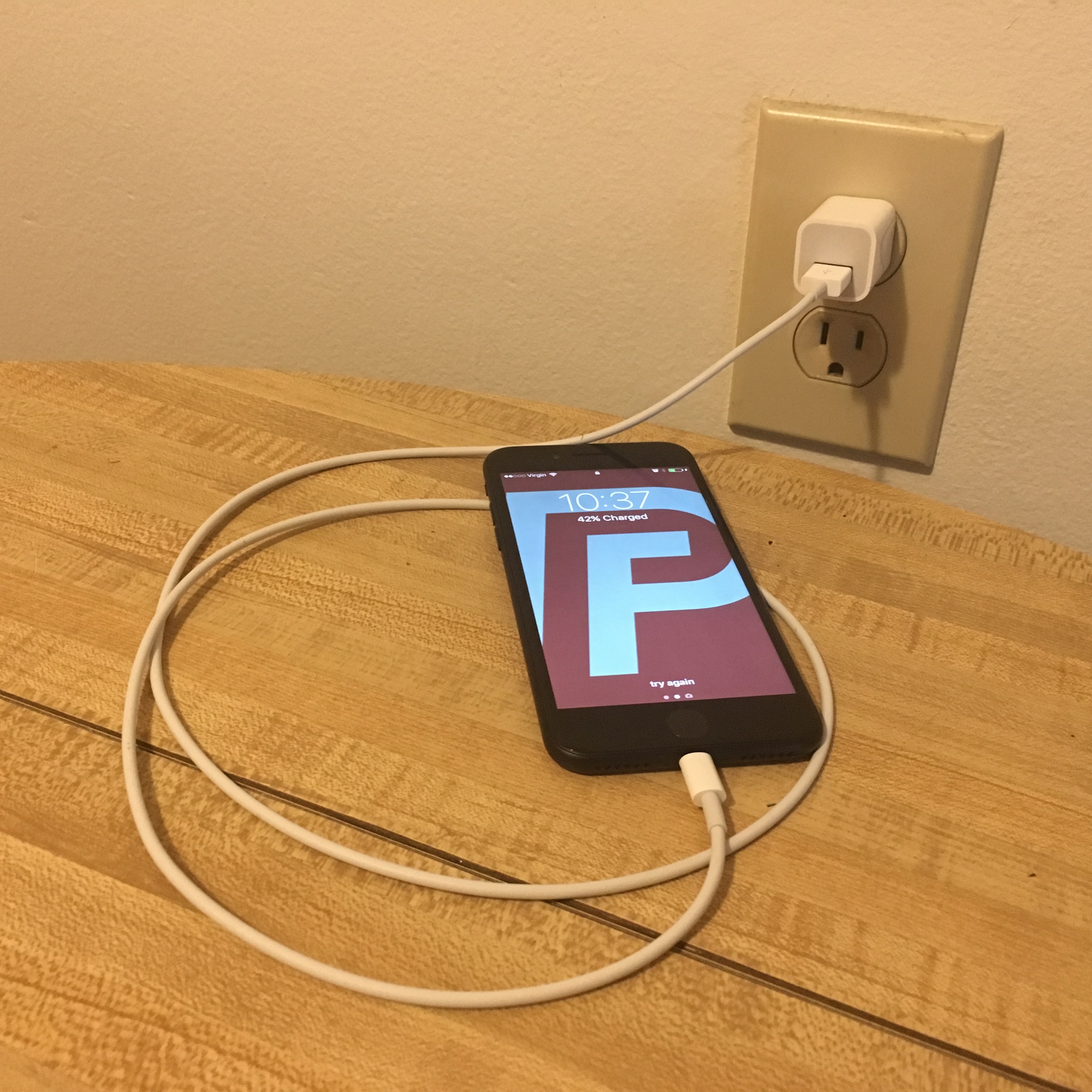 iPhone plugged into wall charger