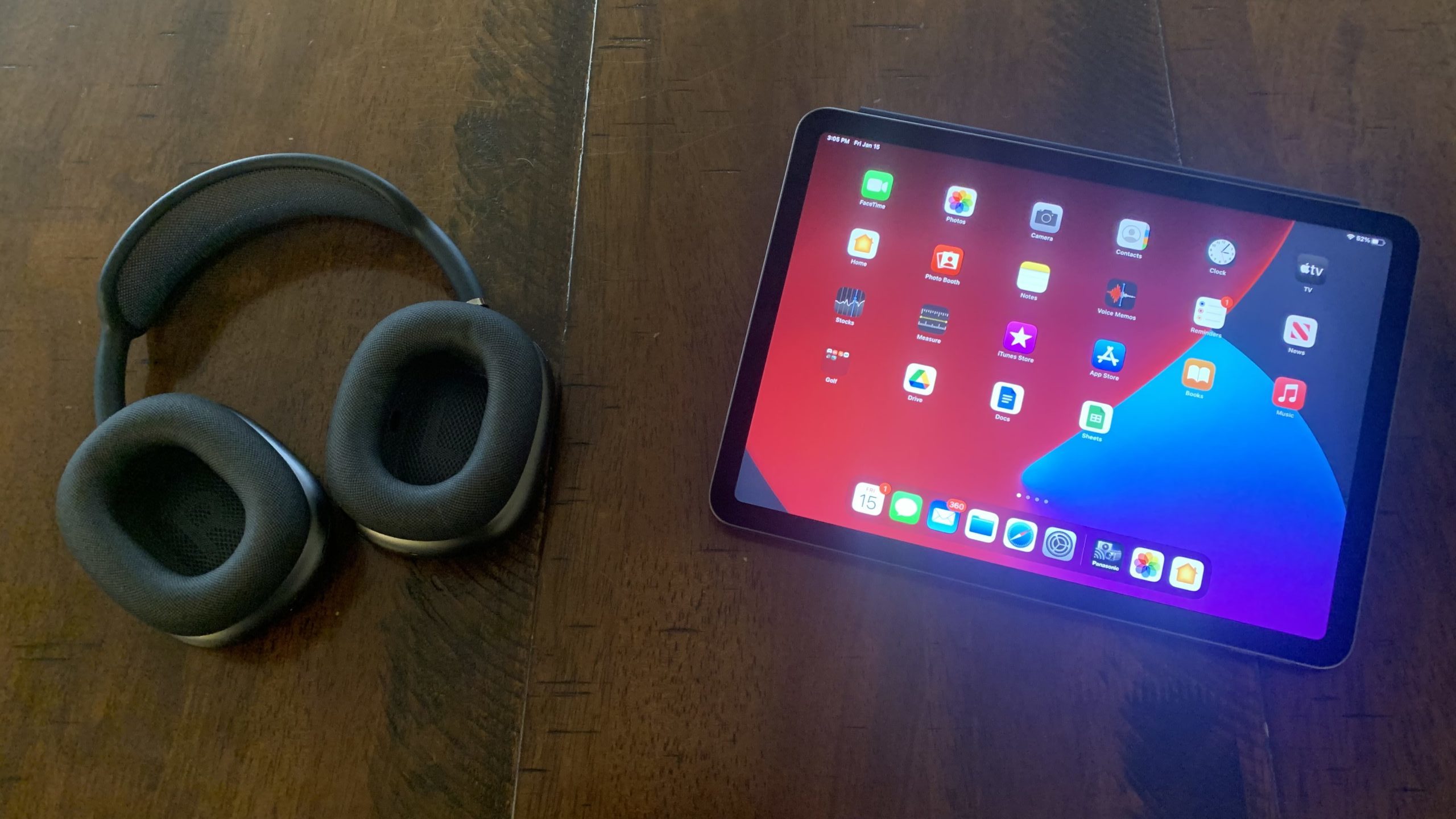AirPods Max next to iPad homescreen